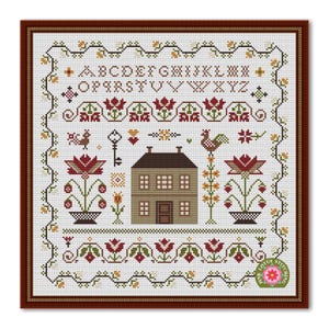 May include: Cross-stitch sampler with a brown wooden frame. The design features an alphabet, house, flowers, birds, and decorative borders in shades of brown, green, and red on a white background. The text "Lotus Stitching" is in the lower right corner.