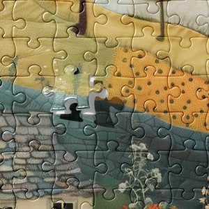 May include: A close-up of a jigsaw puzzle with a missing piece. The puzzle depicts a colourful scene with a house, trees, and flowers. The missing piece is in the centre of the image, and the surrounding pieces are all in place.