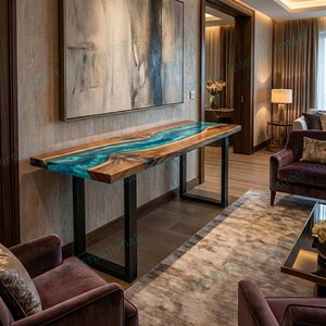 May include: A rectangular console table featuring a natural wood slab top with a central, flowing turquoise resin river inlay. The table is supported by two black metal U-shaped legs and is positioned in a room with a large abstract wall painting.