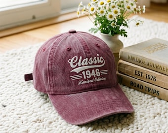 May include: A maroon baseball cap with a distressed finish featuring white embroidered text that reads Classic 1946 Limited Edition. The cap has a curved brim, a button on top, and stitched eyelets on the crown for ventilation and structure.