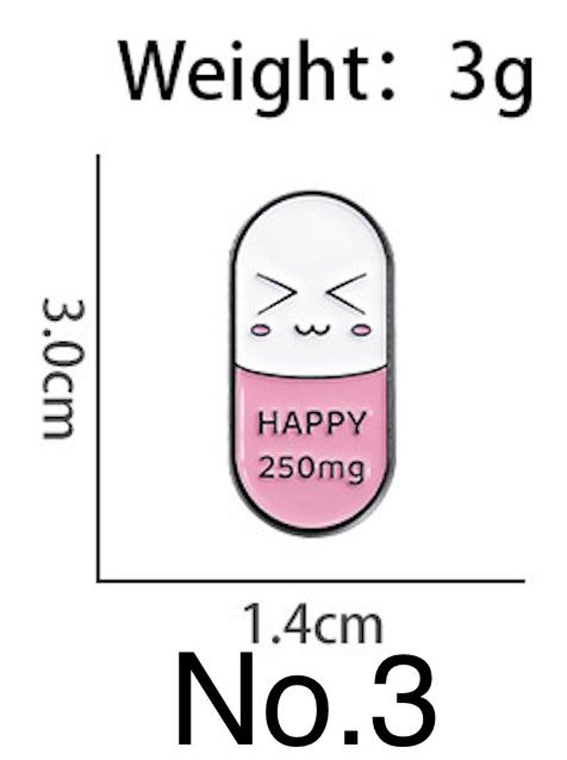 May include: A white and pink enamel pin shaped like a capsule, with a smiling face on the top half. The bottom half reads "HAPPY 250mg". The pin is 1.4 cm wide and 3.0 cm tall, and weighs 3g.