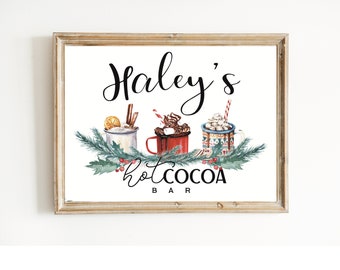 May include: A framed sign with the text "Haley's Hot Cocoa Bar" in black cursive font. The sign features a watercolor illustration of three mugs of hot cocoa with marshmallows, whipped cream, and chocolate sauce. The mugs are surrounded by green holly leaves and red berries.