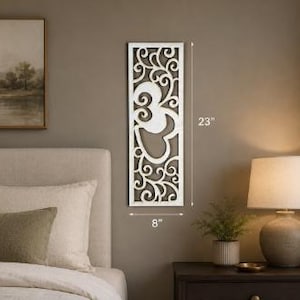 May include: A rectangular white wall panel featuring an intricate laser-cut scrollwork pattern and a central Om symbol. The panel measures 23 inches in height and 8 inches in width, as indicated by the dimension lines visible on the wall.