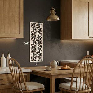 May include: A decorative wooden wall panel with an ornate, symmetrical design, measuring 24 inches high and 8 inches wide. The panel is displayed in a kitchen setting, adding a touch of elegance to the space.