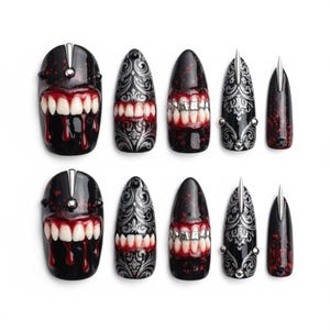 May include: A set of ten black and red press-on nails with various designs. Some nails feature a mouth design with white teeth and dripping red accents. Other nails have silver filigree patterns and silver spikes.