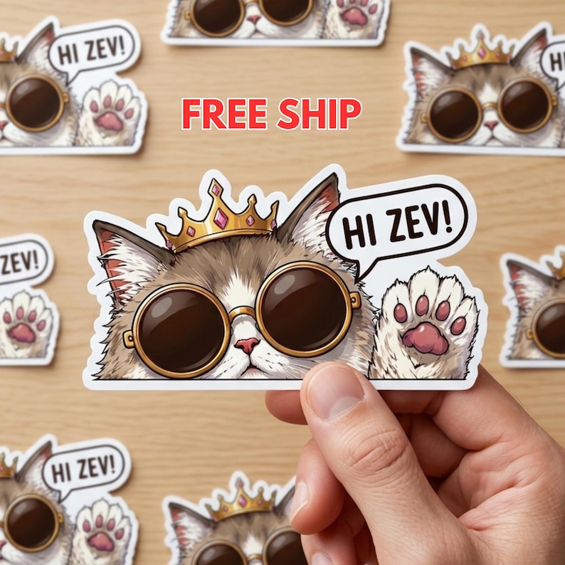 May include: Stickers featuring a cat wearing sunglasses and a crown. The cat has a speech bubble saying "HI ZEV!" and is waving a paw. The stickers are brown, white, and gold.