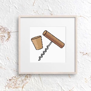 May include: A framed print featuring a corkscrew and a cork. The corkscrew has a brown handle and a silver worm. The cork is a light brown color. The artwork is a pixelated design.