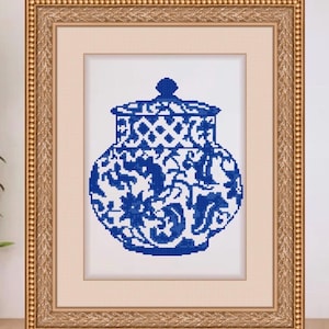 May include: Framed cross-stitch art featuring a blue and white decorative jar with a lid. The jar has a detailed floral and geometric pattern. The frame is gold with a detailed border, set against a neutral background.