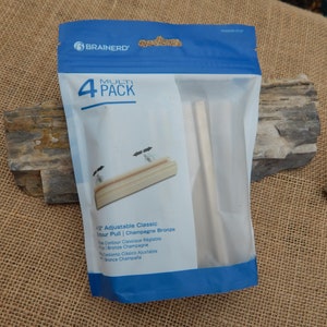 May include: A package of four 4-1/2 inch adjustable classic contour pulls in champagne bronze. The package includes the text "Multi Pack" and "Brainerd".