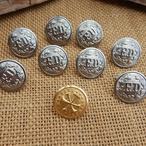 May include: Eight silver buttons with the letters "FD" and a wreath design, and one gold button with a fire department symbol.