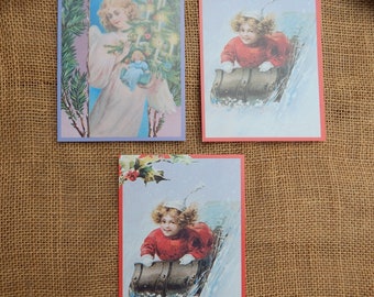 3 Vintage Postcards  /  1988 Girl Sledding Postcard (2) and 1988 Angel Holding Christmas Tree (1)  /  1988 Current Stationary Inc. Postcards