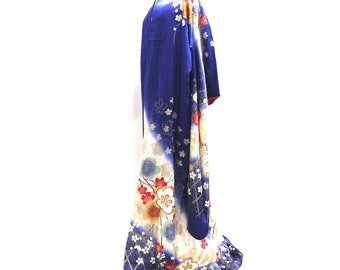 May include: A blue and white kimono with a floral pattern. The kimono is made of silk and has a traditional Japanese design.