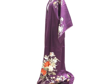 May include: A purple silk kimono with a floral pattern in shades of white, orange, and gold. The kimono is displayed on a mannequin.