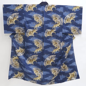 May include: A blue cotton yukata with a repeating pattern of tigers and clouds. The tigers are depicted in a gold and brown color.