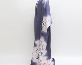 May include: A purple silk kimono with a white and pink floral pattern. The kimono has a long, flowing silhouette and is perfect for special occasions.