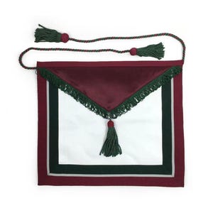 May include: A white apron with a burgundy border and a burgundy satin top. The apron has a green fringe and a green tassel. A green and burgundy rope is attached to the top of the apron.
