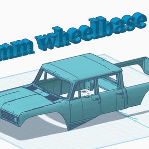 May include: A light blue 3D model of a pickup truck body shell featuring a crew cab design. The text 165mm wheelbase is displayed in large, three-dimensional blue letters above the vehicle model, indicating the specific wheelbase measurement.