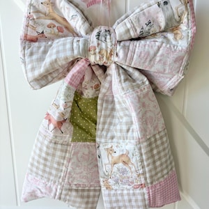 May include: A white ceramic mug with a black handle and the text "But First, Coffee" in a black, handwritten-style font. The mug is on a white surface.