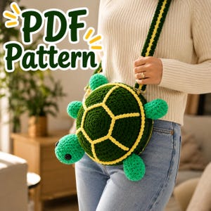 May include: A crochet turtle-shaped crossbody bag featuring a dark green shell with yellow outlines, light green limbs, and a matching green and yellow strap. The text "PDF Pattern" is displayed in large green letters in the upper left corner.
