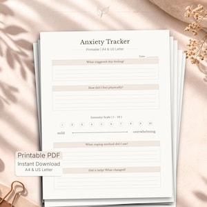 May include: A stack of printable anxiety tracker sheets. The top sheet has the title "Anxiety Tracker" and prompts for recording feelings, physical sensations, coping methods, and results. The scale ranges from mild to overwhelming.
