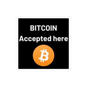May include: Square sticker with a black background and white border. The text "BITCOIN Accepted here" is displayed in white. A Bitcoin logo, an orange circle with a white "B" symbol, is at the bottom.