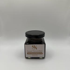 May include: A square glass jar with a black lid, filled with dark brown vanilla bean paste. The label reads "Sweet November" and "Sumatra Indonesian Vanilla Bean Paste." The jar contains 4 fl oz (120 ml) of paste.