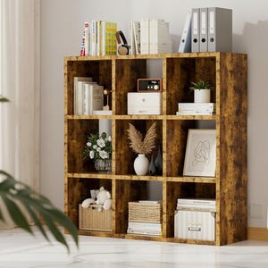 May include: A nine-cube wooden bookshelf with a distressed brown finish. The shelves are filled with books, decorative items, and storage boxes. The bookshelf is a stylish storage solution for any room.
