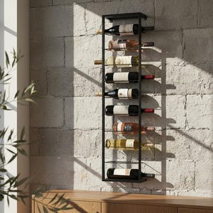 May include: A black metal wine rack mounted on a textured stone wall, holding several bottles of wine. The rack is rectangular and has multiple shelves to display the wine bottles. The bottles are various colors.