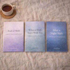 May include: Three books with titles "End of Shift", "When a Shift Stays With You", and "After a Night Shift". Each book has a gradient cover and the text "A Reflection Space for Healthcare Staff". A cup of coffee sits on a coaster.