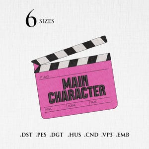 May include: An embroidery design of a pink film clapperboard with black and white diagonal stripes on the top arm. The text MAIN CHARACTER is centered in black, with labels for STUDIO, ROLL, SCENE, and TAKE. Text 6 SIZES and file formats appear.