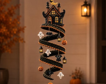 May include: A hanging spiral decoration featuring a dark crochet structure topped with a yellow crescent moon. The spiral is adorned with small crocheted ghosts, orange pumpkins, black bats, a black cat, and miniature lanterns with warm glowing lights.