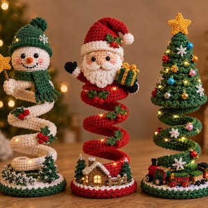 May include: Three crocheted holiday figures featuring a snowman in a green hat, Santa Claus holding a gift, and a decorated Christmas tree with a train. Each figure has a spiral base, integrated warm string lights, and festive details.