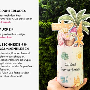 May include: A cylindrical paper box with a summer theme featuring a palm tree, coconut drink, and starfish topper. The box displays the text 'Sch&ouml;ne Sommerferien!' and illustrations of a sandcastle, bucket, and sun. Instructions for assembly are listed.