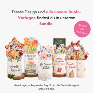 May include: A collection of five cylindrical containers decorated with various colorful illustrations, including holiday themes, flowers, and school supplies, with German text printed on each, displayed on small wooden circular bases.