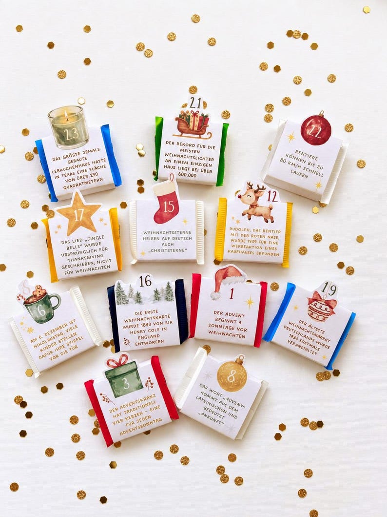 May include: A collection of ten square chocolate bars wrapped in white paper, each featuring a unique Christmas-themed illustration, a numbered tab, and German text detailing holiday facts, accented by scattered gold confetti pieces.