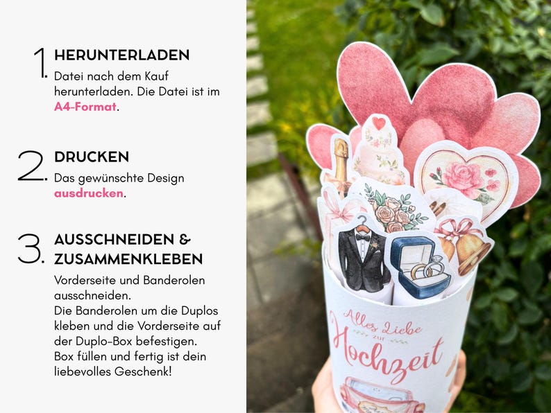 May include: A DIY wedding gift box project featuring a white cylindrical container with the text Alles Liebe Hochzeit, decorated with paper cutouts of a tuxedo, wedding rings, champagne, flowers, bells, and pink hearts on a white background.