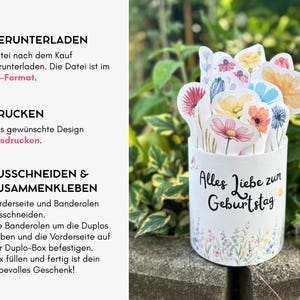 Puede incluir: Una caja de regalo cil&iacute;ndrica blanca con el texto en alem&aacute;n 'Alles Liebe zum Geburtstag' y un colorido arreglo floral de acuarela en la parte superior. El lado izquierdo muestra instrucciones en alem&aacute;n: 1. HERUNTERLADEN, 2. DRUCKEN, 3. AUSSCHNEIDEN & ZUSAMMENKLEBEN.