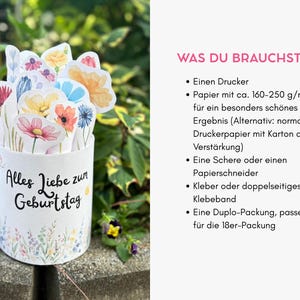 Puede incluir: Un recipiente cil&iacute;ndrico de papel blanco con el texto en alem&aacute;n Alles Liebe zum Geburtstag y un borde floral colorido. Dentro hay varios recortes de flores de papel estilo acuarela en tonos amarillos, rosas, azules y rojos.