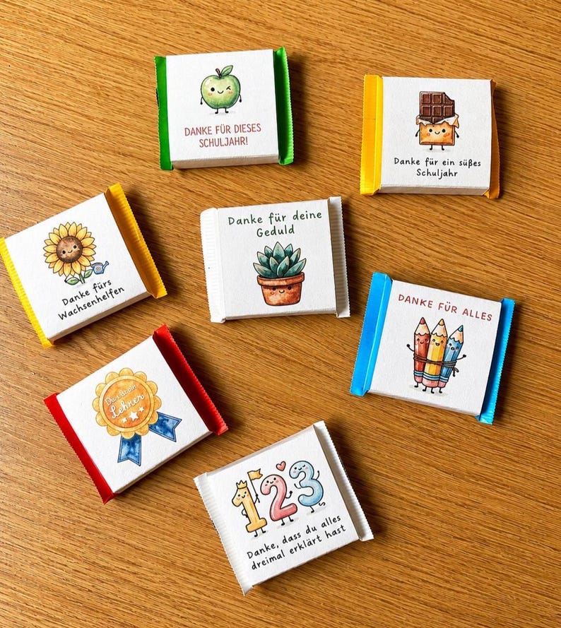 Op de afbeelding: Zeven kleine vierkante chocoladerepen verpakt in wit papier met gekleurde folieranden. Elke wikkel bevat een unieke handgetekende illustratie en Duitse tekst, waaronder afbeeldingen van een appel, chocolade, zonnebloem, vetplant, potloden, een medaille en cijfers.
