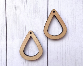 May include: Two unfinished wooden teardrop-shaped earrings with a hole at the top for hanging.