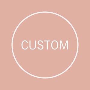 May include: A white circle with a white outline on a light pink background. The word "CUSTOM" is written in white inside the circle.