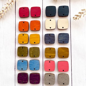 May include: Twenty-four wooden square buttons in various colors, including red, orange, yellow, green, blue, pink, purple, and gray. The buttons have two holes each.