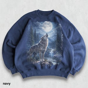 May include: Navy blue sweatshirt with a detailed graphic of a howling wolf under a full moon in a forest setting. The design includes a waterfall and mountain range. The word "navy" is printed at the bottom.