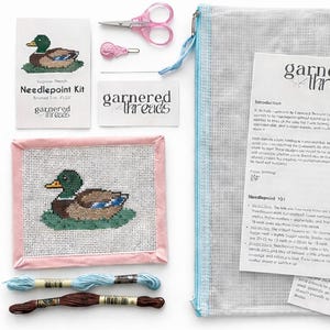May include: Needlepoint kit featuring a mallard duck design. Includes a canvas, threads, scissors, and instructions. The finished size is 5 x 5 inches. The kit is from Garnered Threads.