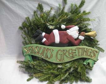 Santa on Seasons Greetings sign