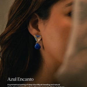 May include: A triangular earring featuring deep blue and white Miyuki beads arranged in a geometric pattern, accented with a gold-toned border. A smooth, teardrop-shaped deep blue stone hangs from the base of the beaded triangle structure.