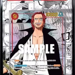 May include: A graded trading card featuring Shanks from the 2022 One Piece manga series. The card has a red and white design with the word "SAMPLE" across the front. The card is encased in a protective holder.