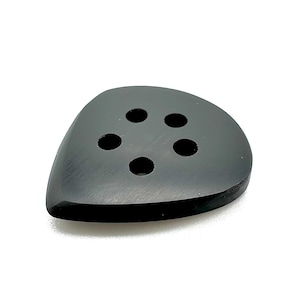 May include: A black, teardrop-shaped button with five evenly spaced holes. The button has a smooth, matte finish and a slightly rounded edge. The button is likely for clothing or crafts.