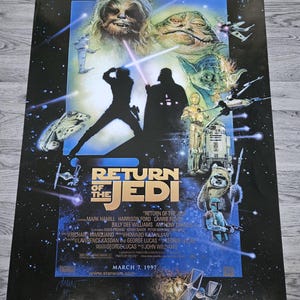 May include: A Special Edition poster for "Return of the Jedi" featuring Chewbacca, Yoda, Darth Vader, and other characters. The poster has a dark blue background with the movie title and credits. The release date is March 7, 1997.