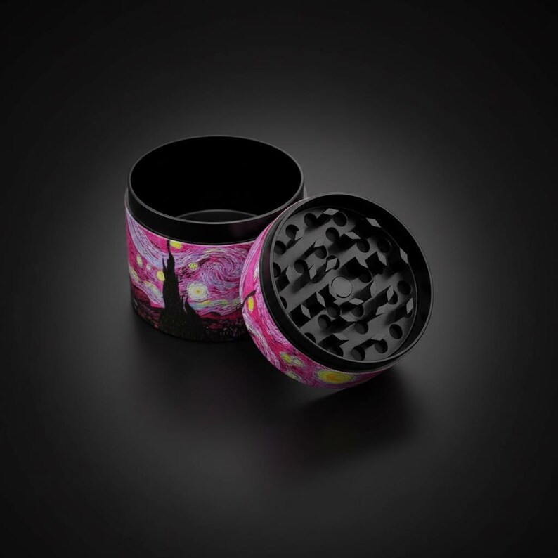 May include: A two-piece grinder with a black interior and a vibrant exterior featuring a starry night design in pink, yellow, and purple. The grinder is open, revealing the grinding teeth.
